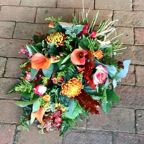 Single ended funeral spray of mixed fresh flowers and foliage