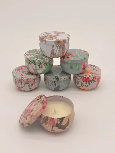 Small pink floral print scented candle in a tin