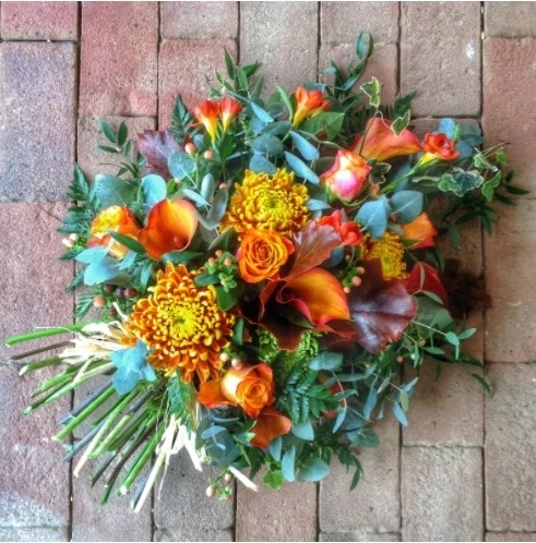 Single ended funeral spray of mixed fresh flowers and foliage