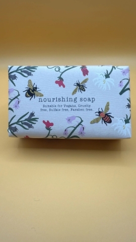 Honey scented nourishing soap bar in bee print packaging